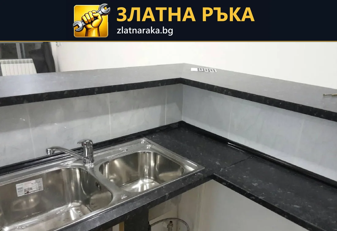 Две метални корита са вградени в тъмен ъглов плот над отворена долна зона с видими тръби