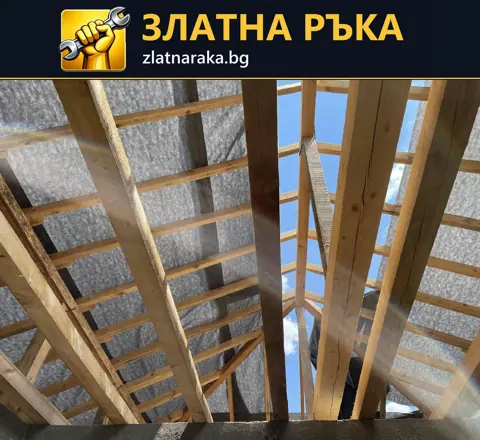 Поглед отдолу към греди, летви и сив покривен слой с открит участък по средата.