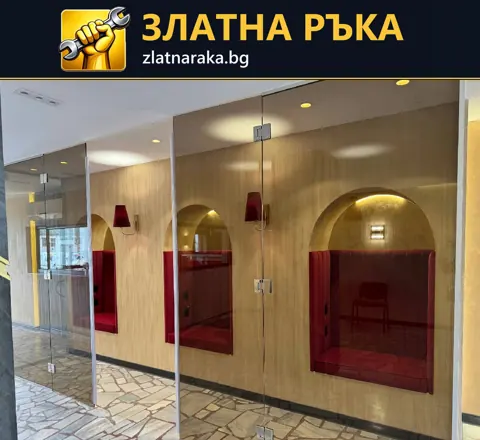 Прозрачни стъклени врати пред декоративна стена с дървесен декор и червени арковидни ниши