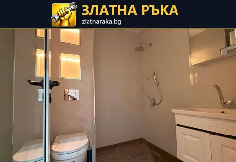 Баня със светли стени, топло осветени правоъгълни ниши, душова зона и широк бял шкаф