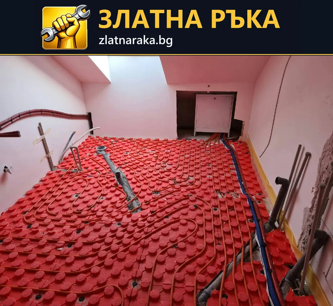 Сиви тръби се извиват върху червена релефна подложка в малко помещение с розови стени